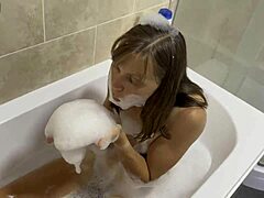 Mature brunette sings in the bath