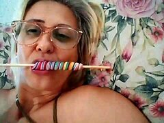Mature pornstar Stella Still enjoys licking a lollipop in HD video