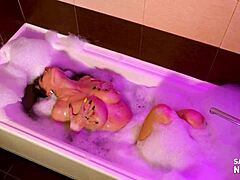 Mature woman gives a blowjob while taking a bath