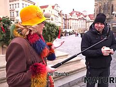 O femeie în vârstă se bucură de stilul câinelui cu un bărbat tânăr în Praga